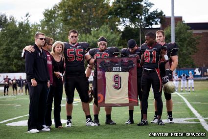 From left, Jason, Richard and Nikki Zieba, Anthony Barrette, Daryl Rankin, Liam Mahoney, Cory Watson, and Kristian Matte stand tall during the memorial for Ricky Zieba.